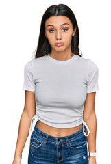 Obraz premium Young hispanic girl wearing casual white t shirt depressed and worry for distress, crying angry and afraid. sad expression.