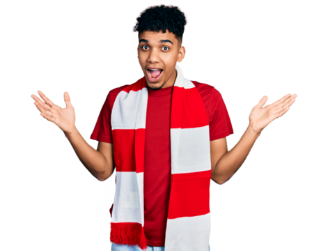 Young african american man football hooligan cheering game celebrating victory with happy smile and winner expression with raised hands