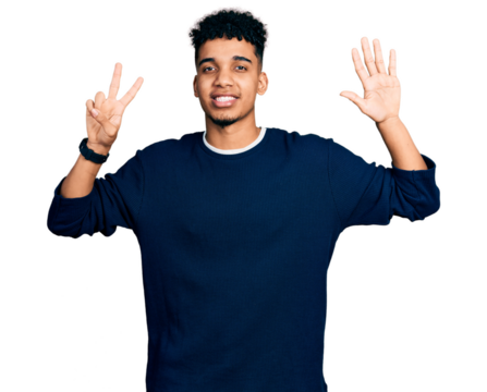 Young african american man wearing casual clothes showing and pointing up with fingers number seven while smiling confident and happy.