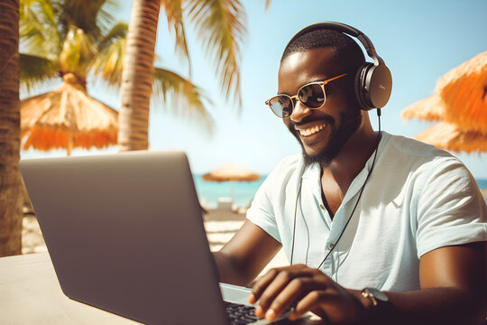 black man working remotely on laptop on summer vacation - happiness digital nomad remote work business lifestyle concept