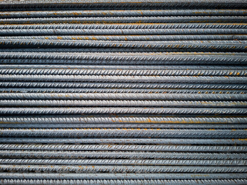 Background of horizontally aligned corrugated steel bars for construction with reinforced concrete