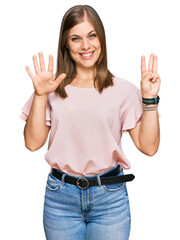 Beautiful caucasian woman wearing casual clothes showing and pointing up with fingers number eight while smiling confident and happy.