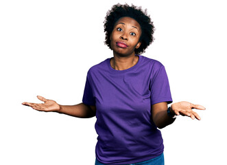 African american woman with afro hair wearing casual purple t shirt clueless and confused...
