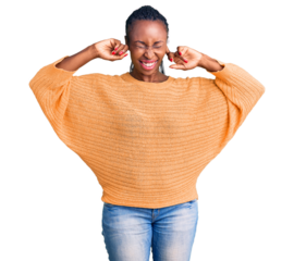Young african american woman wearing casual clothes covering ears with fingers with annoyed expression for the noise of loud music. deaf concept.