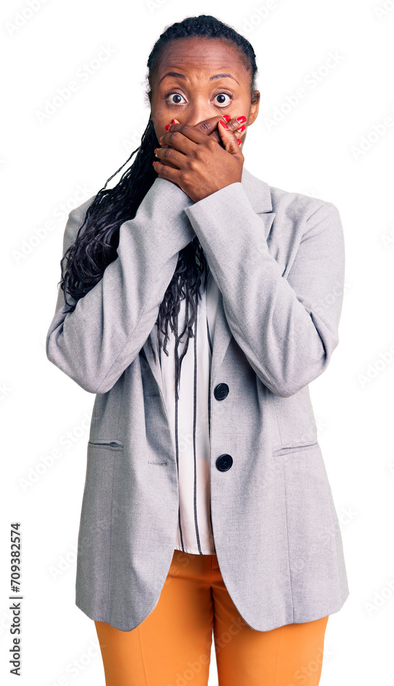 Wall mural young african american woman wearing business clothes shocked covering mouth with hands for mistake.