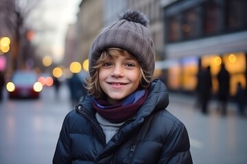 Portrait of a cute little boy in winter clothes on the street