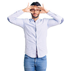 Handsome hispanic man wearing business shirt and glasses trying to open eyes with fingers, sleepy and tired for morning fatigue