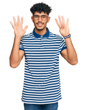 Young arab man wearing casual clothes and glasses showing and pointing up with fingers number nine while smiling confident and happy.