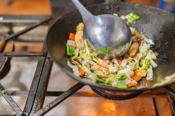 Wok frying pan with vegetables and chicken