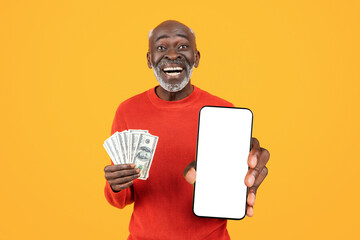 Glad old african american man show credit card and mobile phone with blank screen