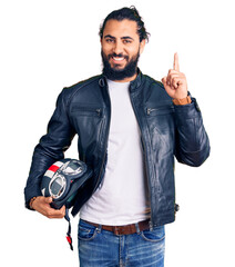 Young arab man holding motorcycle helmet surprised with an idea or question pointing finger with...