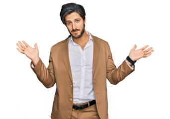 Young hispanic man wearing business clothes clueless and confused expression with arms and hands raised. doubt concept.