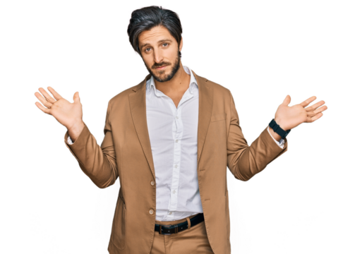 Young hispanic man wearing business clothes clueless and confused expression with arms and hands raised. doubt concept.