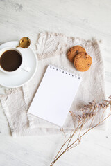 Cup of coffee with cookies and a little notepad list copy space