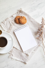 Cup of coffee with cookies and a little notepad list copy space