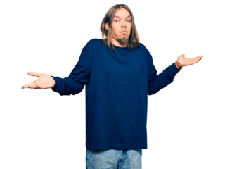 Handsome caucasian man with long hair wearing casual winter sweater clueless and confused expression with arms and hands raised. doubt concept.