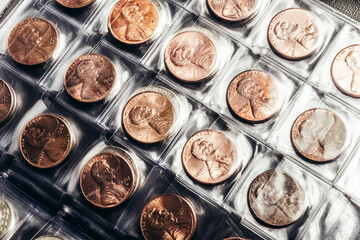 Photo of US president Lincoln cent coins collection in a clear plastic sheet numismatic holder. - obrazy, fototapety, plakaty