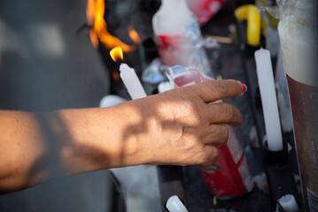 Catholics light candles for Santa Luzia during mass at Pilar Church in the city of Salvador, Bahia.