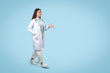 Happy woman doctor gesturing, casual attire with lab coat, free space