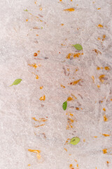 Crushed greasy paper background with thyme leaves