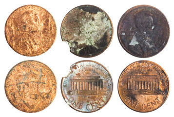 Isolated photo of old rusty and damaged american 1 cent coins on white background.