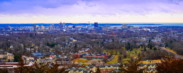New Haven Skyline Panorama over Long Island Sound Horizon with dramatic clouds on a stormy winter morning, a view from the West Rock State Park Overlook in Connecticut, USA - obrazy, fototapety, plakaty