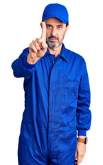 Middle age handsome man wearing mechanic uniform pointing with finger up and angry expression, showing no gesture
