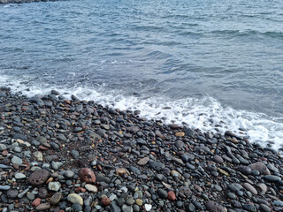 
Jeju Island beach with round basalt rocks.
