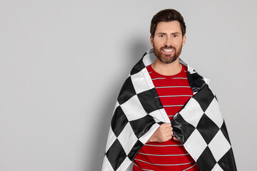Man with checkered flag on white background, space for text