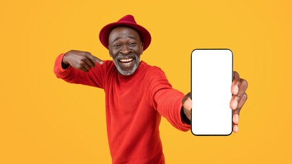 Happy senior black man pointing at a blank smartphone screen with a beaming smile