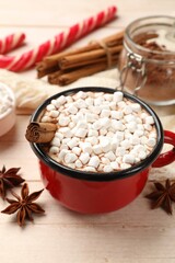 Tasty hot chocolate with marshmallows on white wooden table, closeup