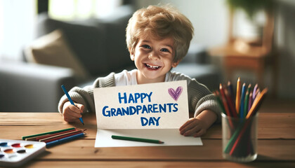 Happy little boy writing a present card for grandmother and grandfather for their grandparents day