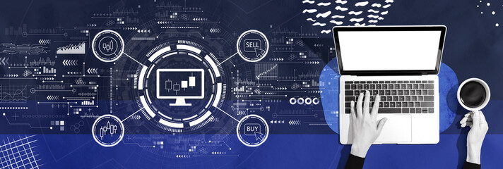 Stock trading theme with person using a laptop computer