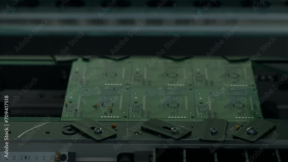 Poster coating machine for printed circuit board at work. creative. close up of automated robotic mechanism