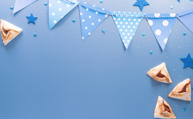 Happy Purim carnival decoration concept made from sparkle star and hamantaschen cookies on pastel background. (Happy Purim in Hebrew, jewish holiday celebrate)