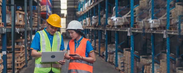 Banner Warehouse management team using laptop check stock inventory. Panorama asian worker use...