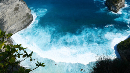 Turquoise ocean sea water white wave splashing deep blue sea. Bird eye view monster wave splash on...