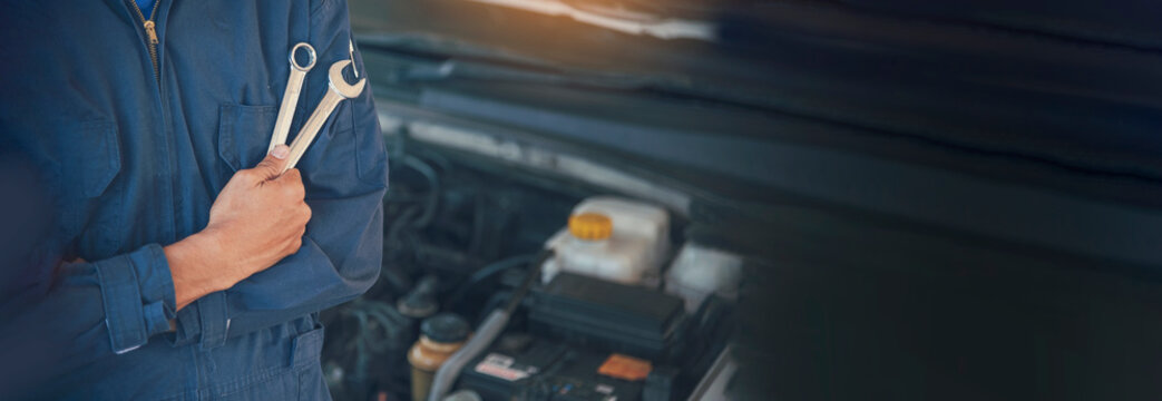Banner Man hands fixing Car machinery vehicle mechanical service. Mechanic man hands repairing car shop. panoramaopen vehicle hood checking up auto mobile. Car maintenance engineer with copy sapce.