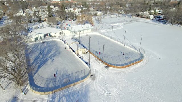 Aerial view of outdoor ice hockey rinks and community centre in Winnipeg, Canada, 4K