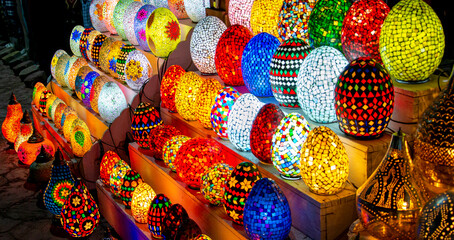 Egyptian mosaic egg shaped lamps. Arabian egg-shaped unique lamps in stock souvenir shop. Traditional Egyptian souvenirs at the street market. - obrazy, fototapety, plakaty