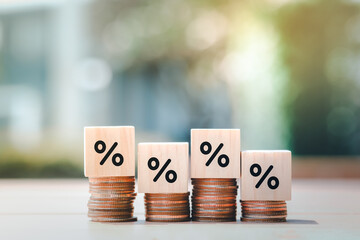 Interest rate finance and mortgage rates. Wooden block with percentage sign on many level of stack of coin. Financial growth, interest rate increase, inflation, sale price and tax rise concept. - obrazy, fototapety, plakaty