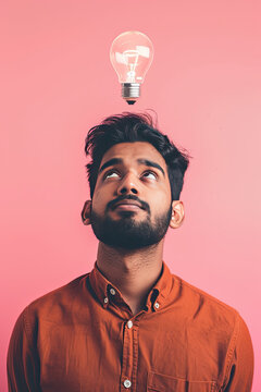 A thinking Indian man with a lightbulb on his head