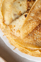 A stack of pancakes with a piece of melted butter