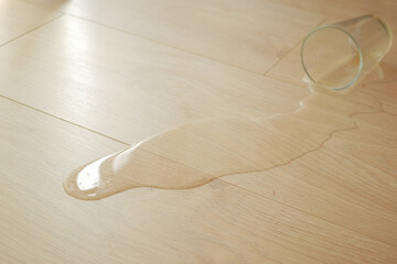 spilled water drops on wooden laminate floor.