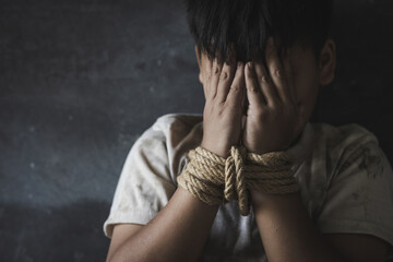 Children who are victims of human trafficking Tied the rope attached to the wrist with stress and emotional pain.Hands of a missing kidnapped, abused, hostage,   afraid, restricted, trapped, - obrazy, fototapety, plakaty