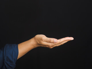 Close-up of an empty open hand palm up. Side view isolated on a black background