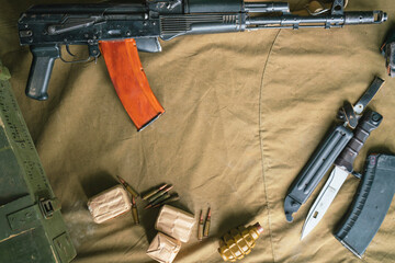 Kalashnikov assault rifle, cartridges, F-1 grenade and bayonet knife, top view