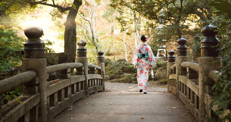 Bridge, culture and Japanese woman in park for wellness, fresh air and walking in nature. Travel,...