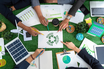 Group of businessmen's hands touching green recycling symbol, showing a mockup of green earth with recycling icons.