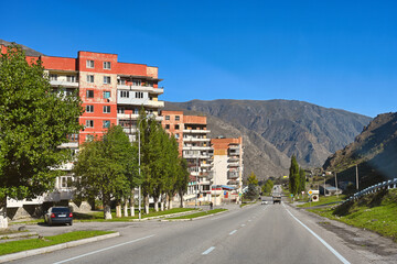 Fototapeta na wymiar Residential buildings along the road in Tyrnyauz mountain city